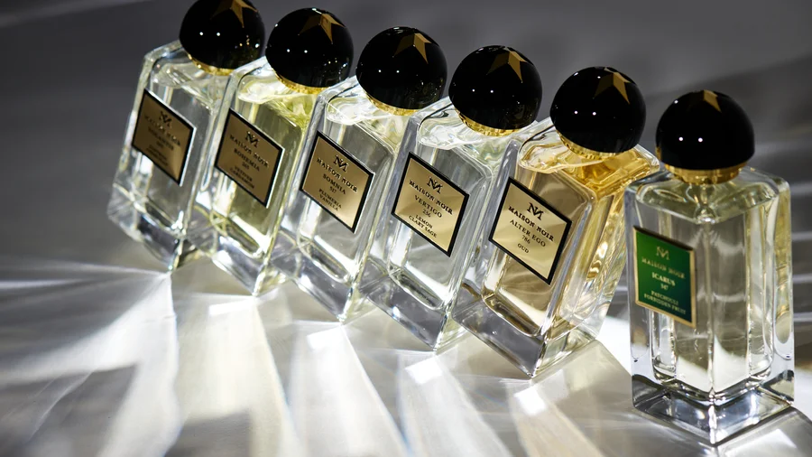 Perfume bottles from Maison Noir with embossed aluminum labels for exclusive product identification.
